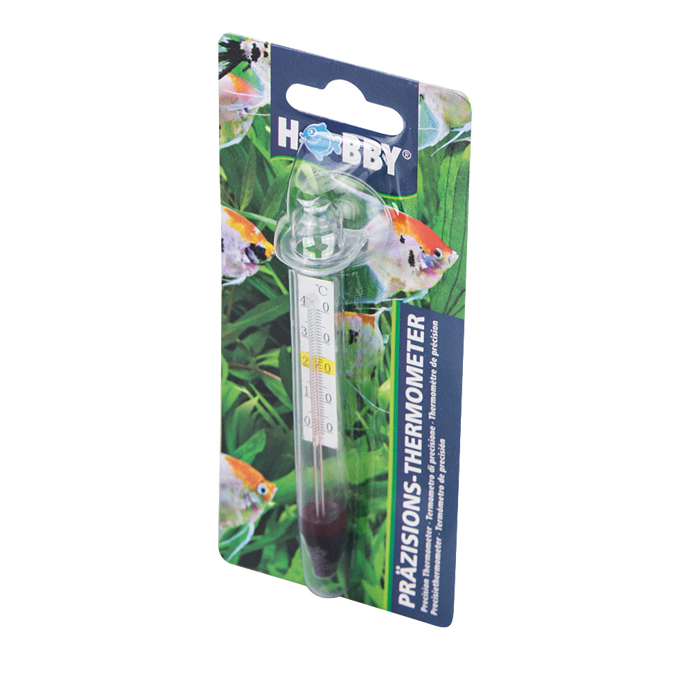 Un HOBBY Thermomètre de précision emballé avec une ventouse est présenté sur fond de poissons et de plantes aquatiques vertes, avec l'emballage étiqueté PRÄZISIONS-THERMOMETER et HOBBY.